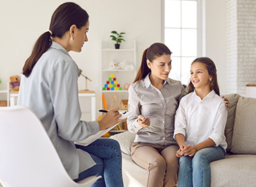 Talking is key to understanding. Parent and child seeing psychologist together. Counseling therapist and mother listening to preteen daughter sharing school news, telling story and answering questions
